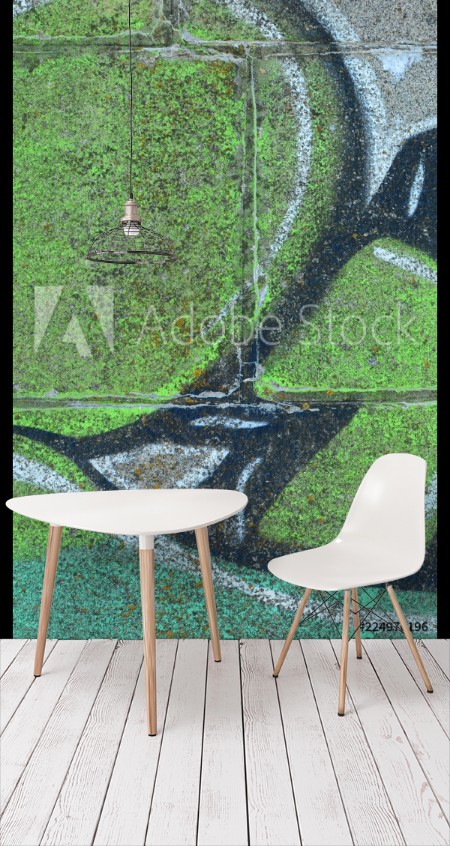 Image de Fragment of graffiti drawings The old wall decorated with paint stains in the style of street art culture Colored background texture in green tones